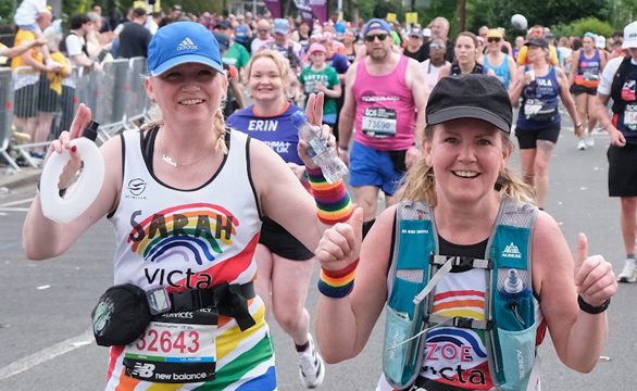 Two ladies run together and give thumbs up