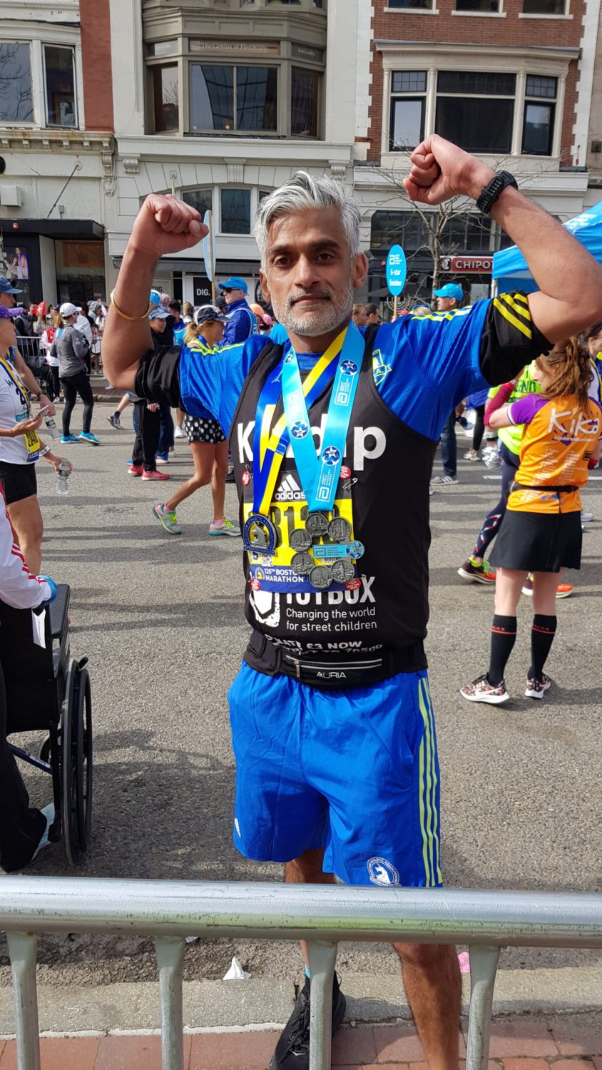Returning Runner Kuldip 5 Denise holding her Boston Marathon medal