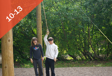 Two boys having fun in a forested area.