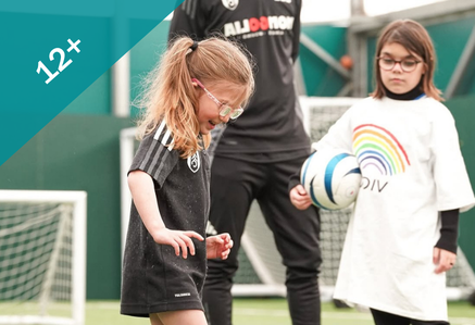 Girls playing football outdoors.