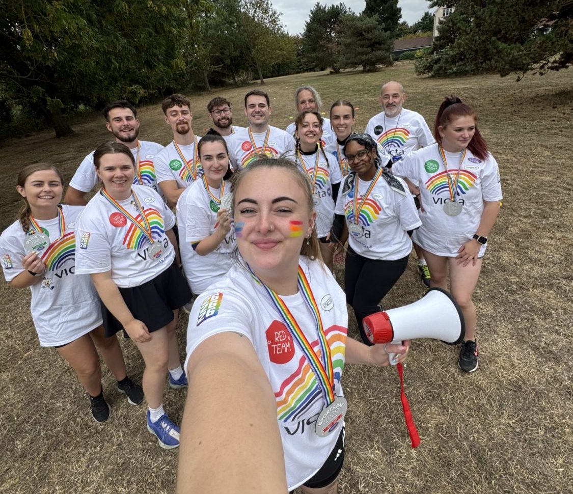 A group sports day selfie with VICTA t-shorts, medals and a megaphone