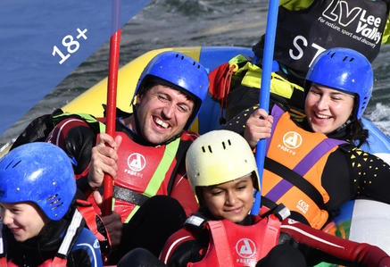 People laughing on a boat white water rafting.