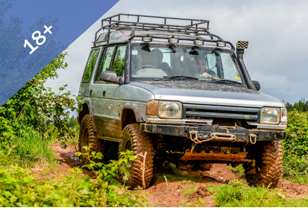 Image of an off road vehicle driving over grass.