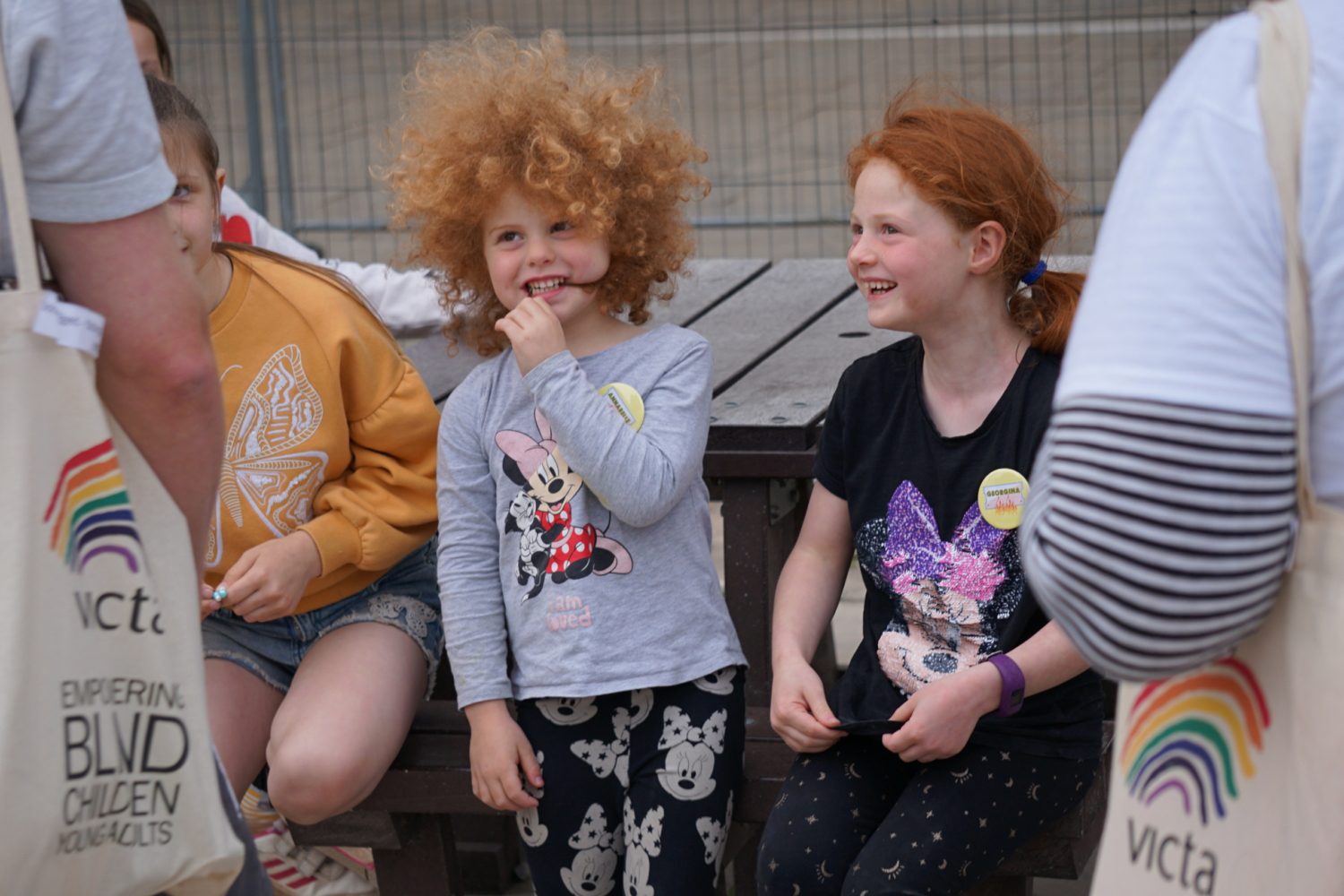Two volunteers laugh together at raft building