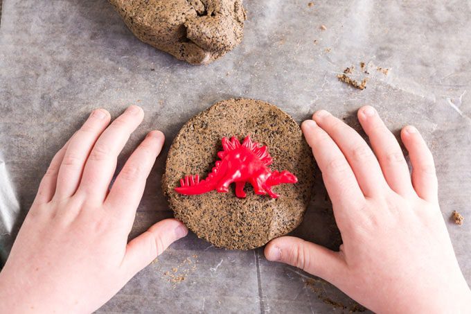Hands moulding a coffee ground fossil.