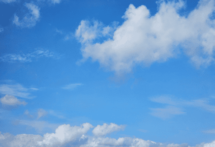 Blue summer sky filled with big fluffy white clouds.