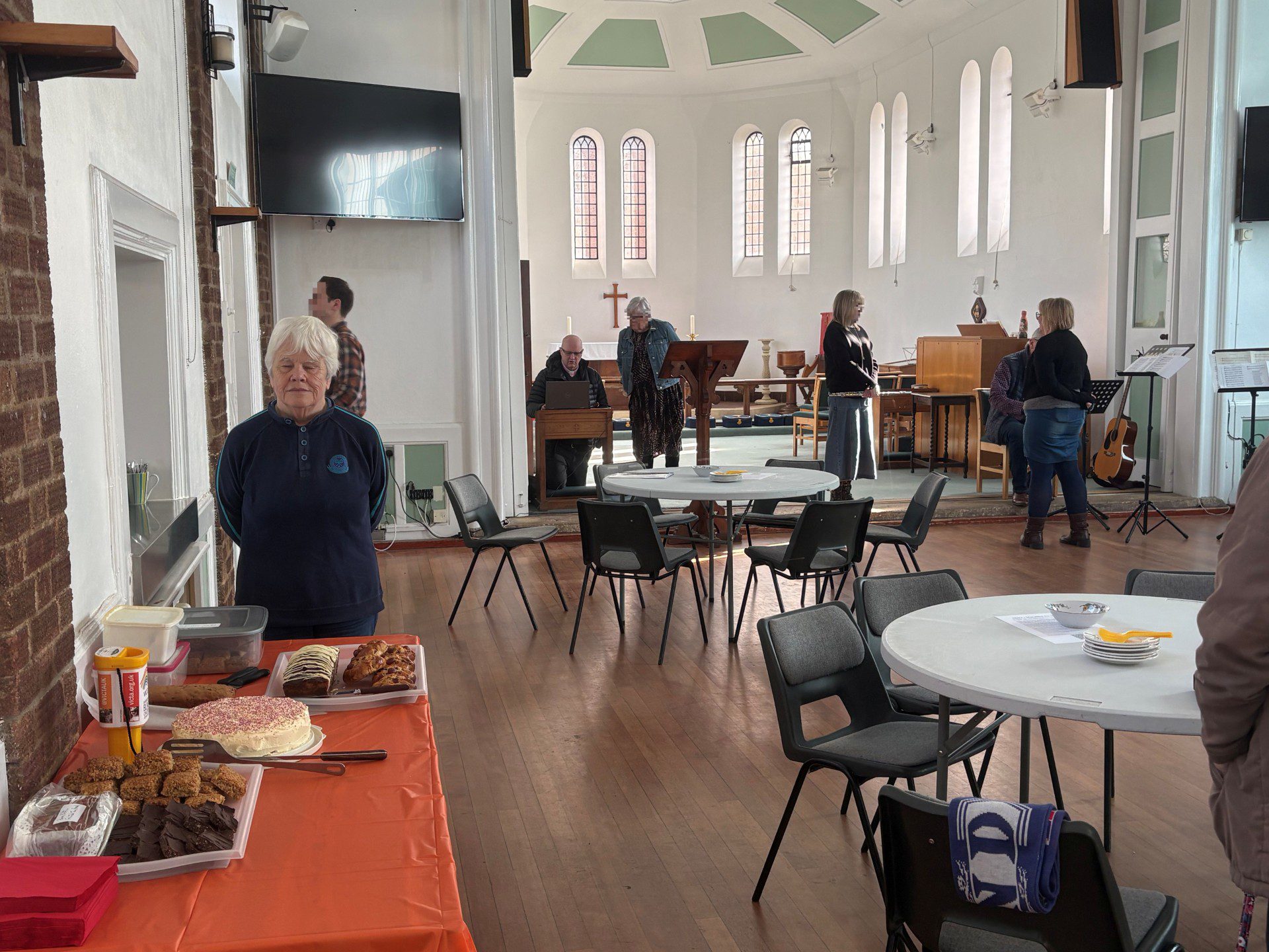 The bake sale in action with Mary standing close to the cake table
