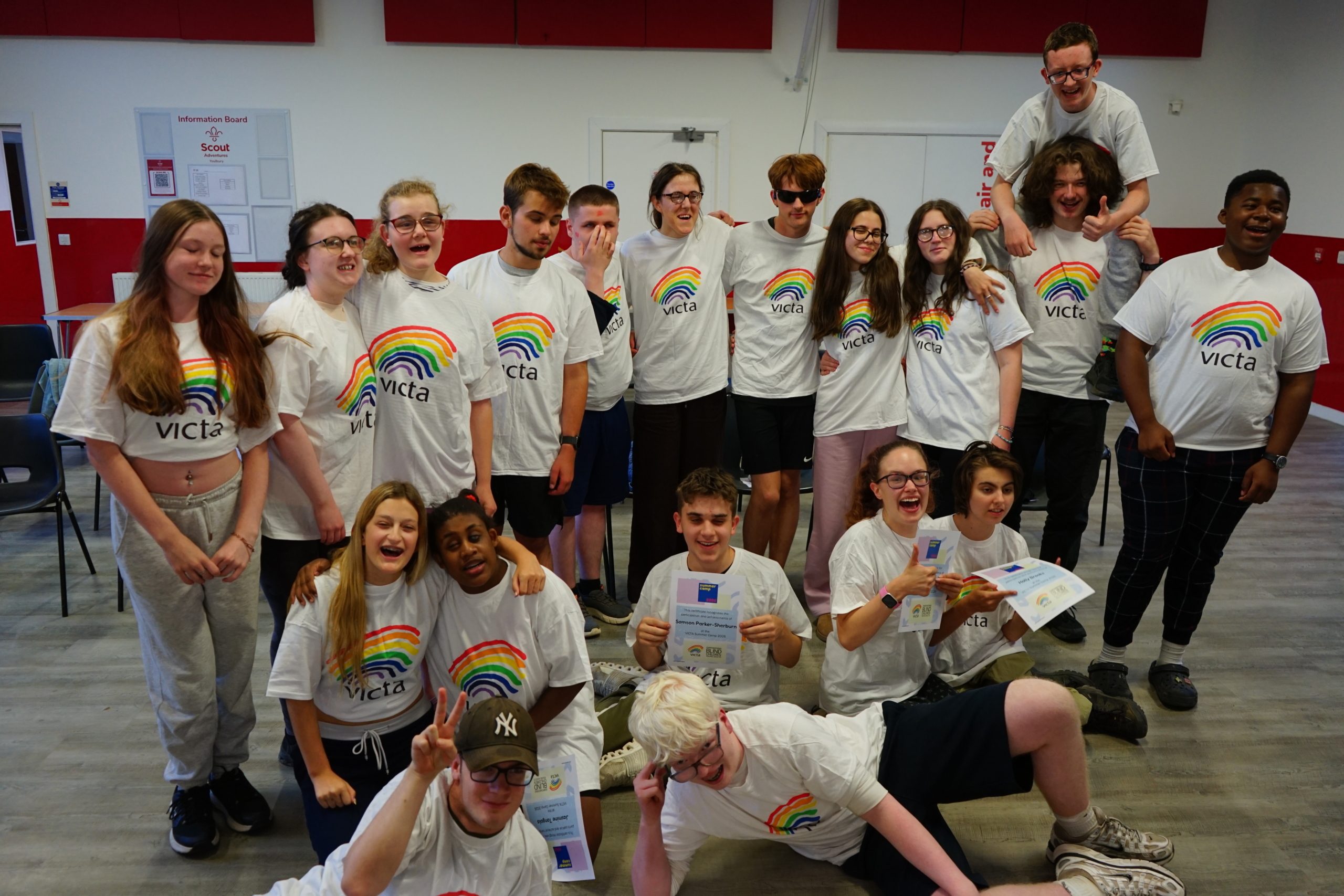A group of teenagers wearing VICTA rainbow t-shirts